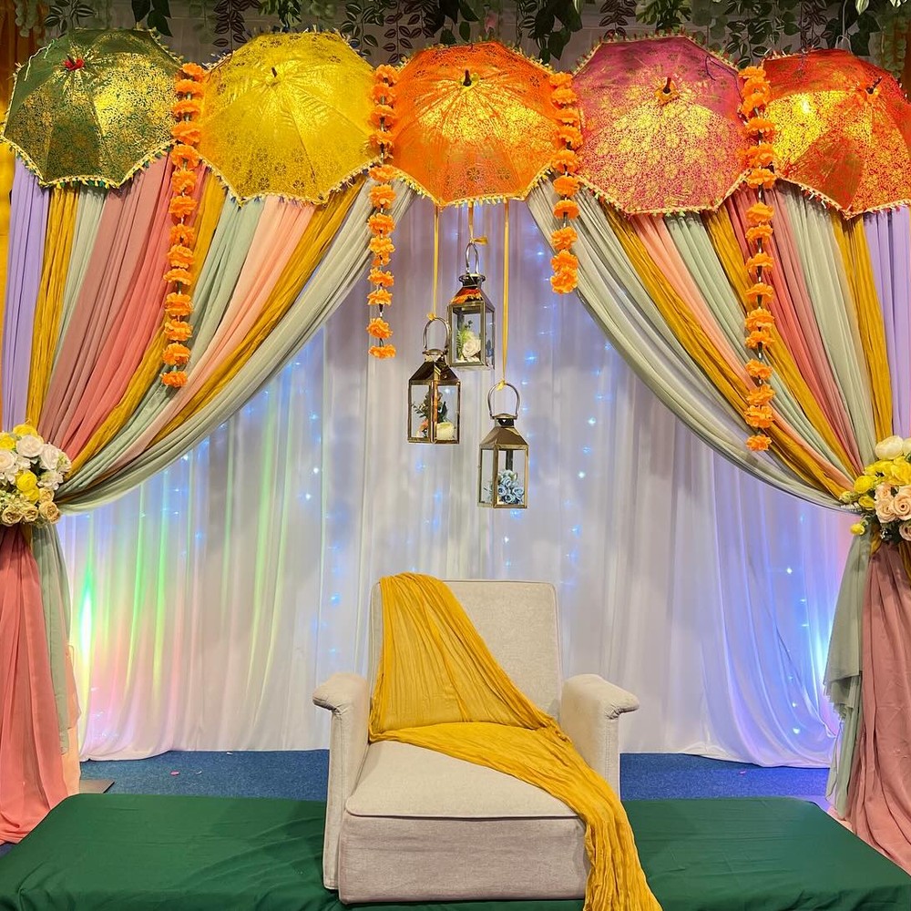 Colourful parasol backdrop for mehendi night