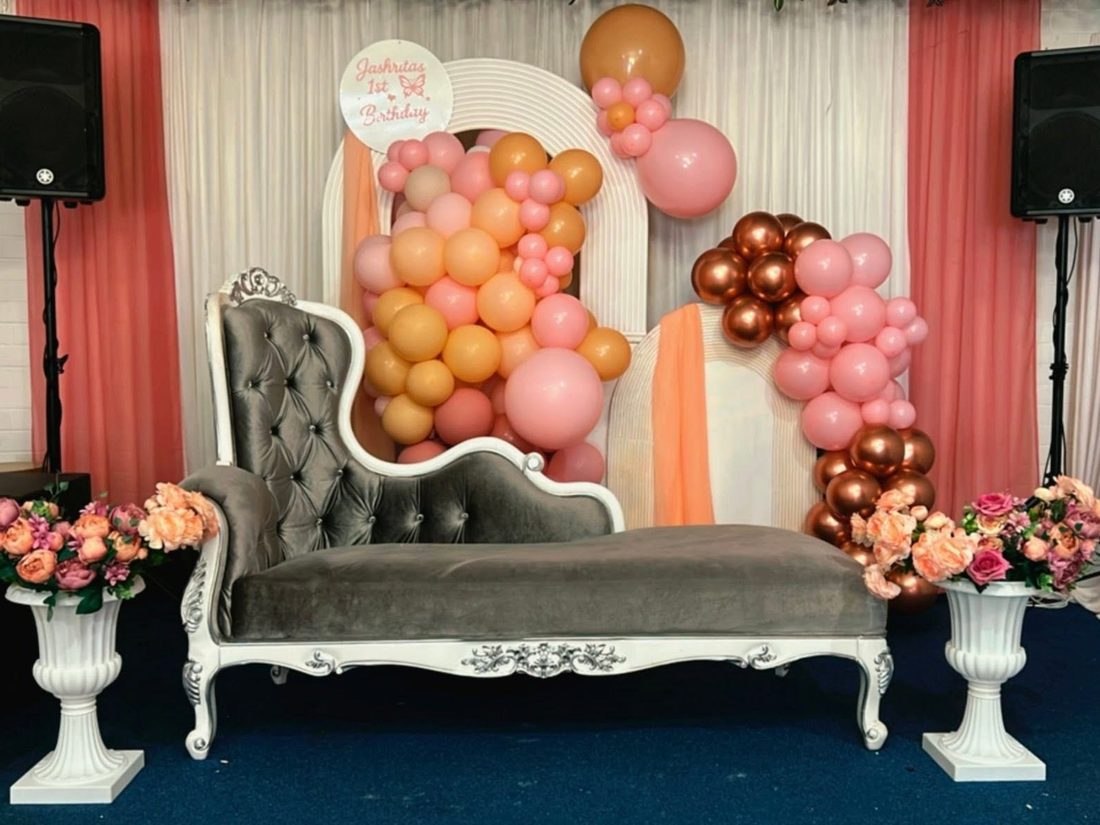 Colourful birthday party table setup with balloon styling