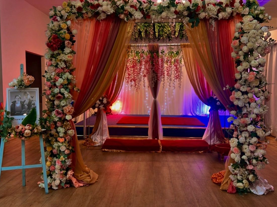 Romantic engagement party setup with arch and florals